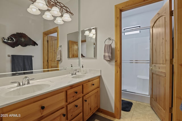 full bath with double vanity, a shower stall, a sink, and tile patterned floors