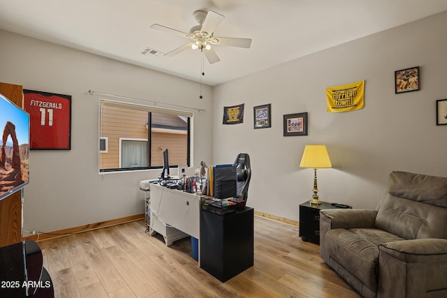 office featuring visible vents, ceiling fan, light wood-style flooring, and baseboards