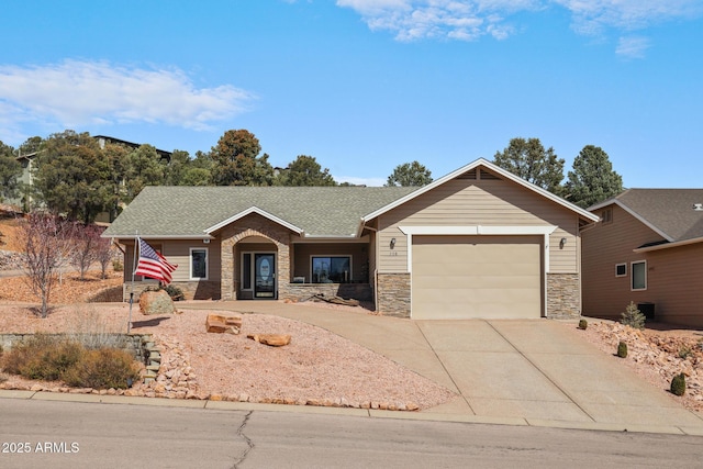 single story home with a garage, stone siding, concrete driveway, and roof with shingles