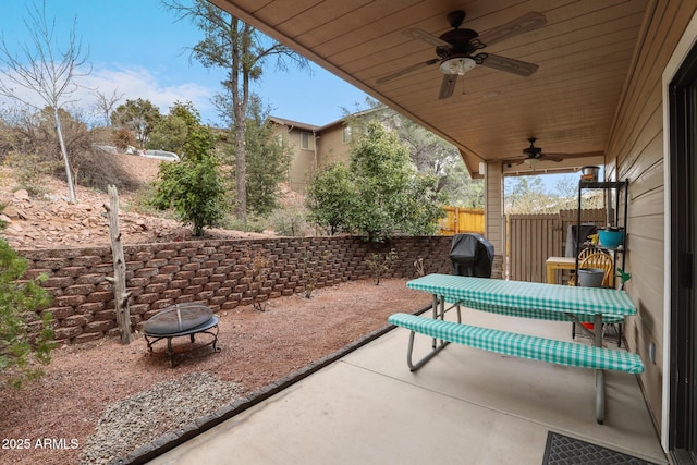 view of patio / terrace featuring a ceiling fan, an outdoor fire pit, and fence