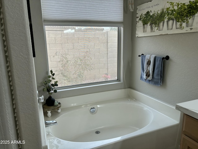 20298 N 108th Ln, Sun City, AZ 85373 - bathroom with a bath, a textured wall, and vanity