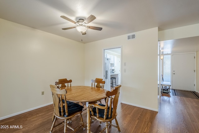 dining area featuring dark hardwood / wood-style floors and ceiling fan