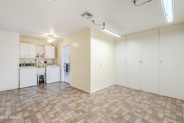 interior space with ceiling fan and washer and clothes dryer