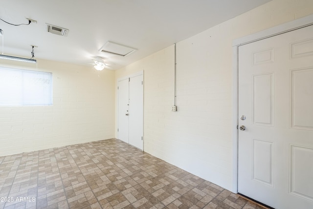 empty room featuring brick wall