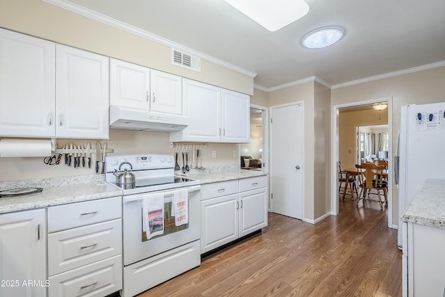 kitchen with white appliances, ornamental molding, and white cabinets