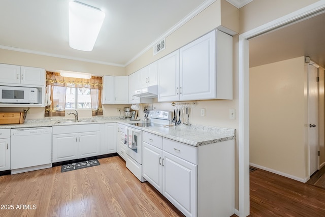 kitchen with crown molding, sink, white cabinets, and white appliances