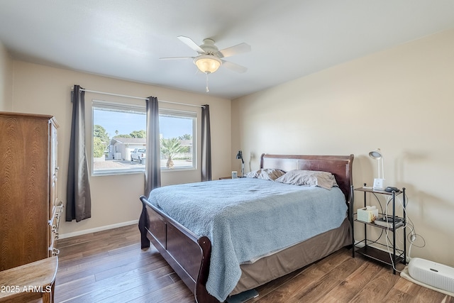 bedroom with dark wood-type flooring and ceiling fan