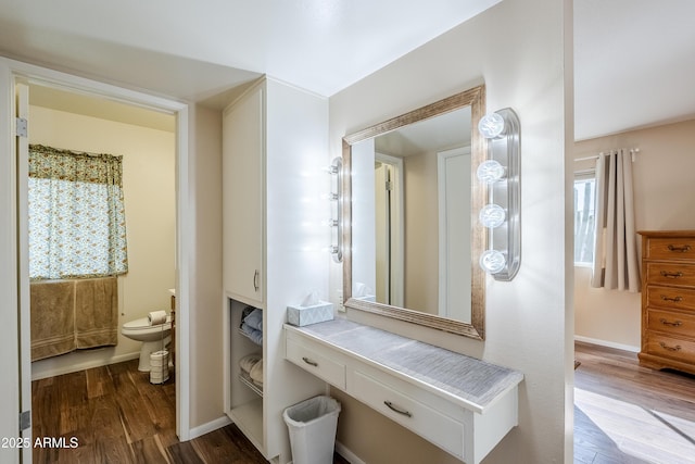 bathroom with vanity, toilet, and hardwood / wood-style floors