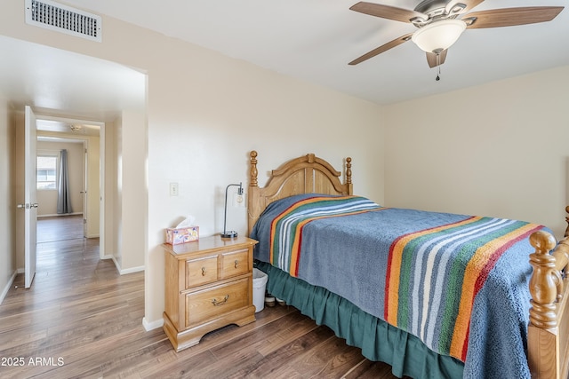 bedroom with hardwood / wood-style floors and ceiling fan