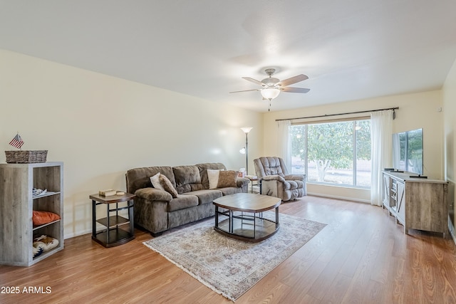 living room featuring ceiling fan and wood-type flooring