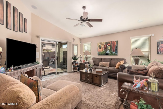 carpeted living room with ceiling fan and lofted ceiling