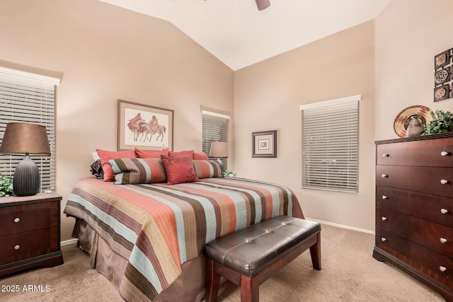 bedroom with ceiling fan, vaulted ceiling, and light carpet