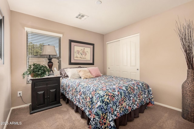 bedroom featuring light colored carpet and a closet