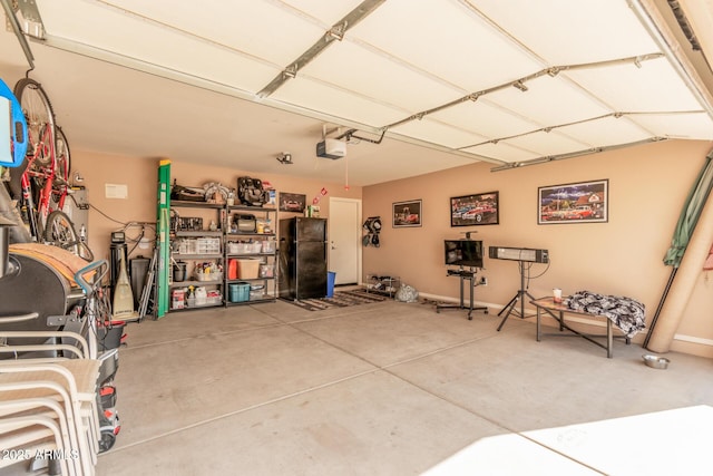 garage with black fridge and a garage door opener