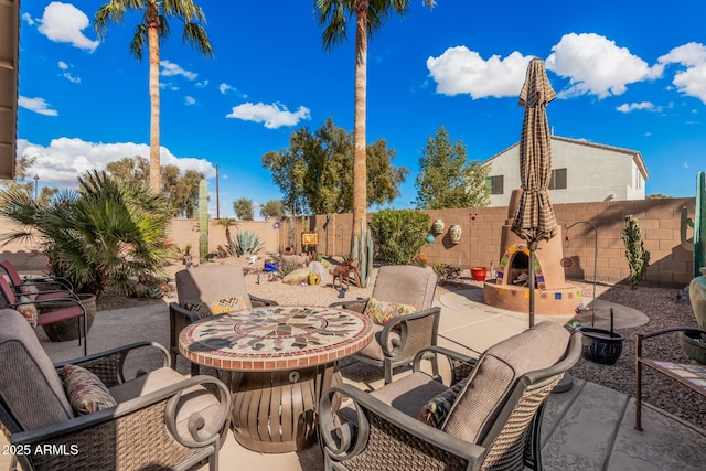 view of patio with a fireplace