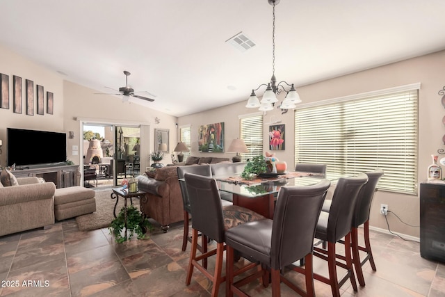 dining space featuring lofted ceiling and ceiling fan with notable chandelier