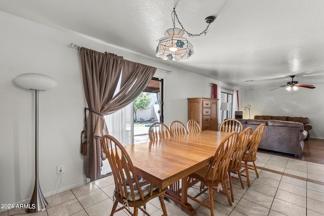 dining space with ceiling fan, light tile patterned floors, and a textured ceiling