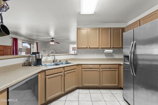 kitchen featuring sink, black dishwasher, stainless steel refrigerator with ice dispenser, a textured ceiling, and light tile patterned floors