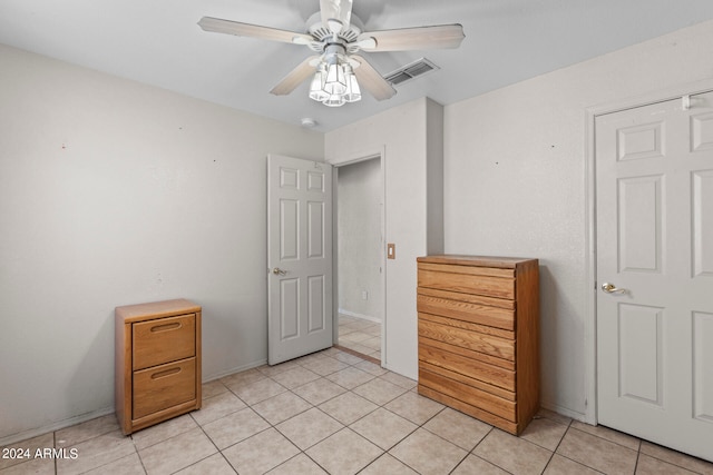 tiled bedroom with ceiling fan