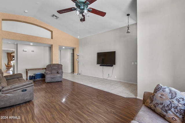 living room featuring light wood-type flooring, vaulted ceiling, and ceiling fan