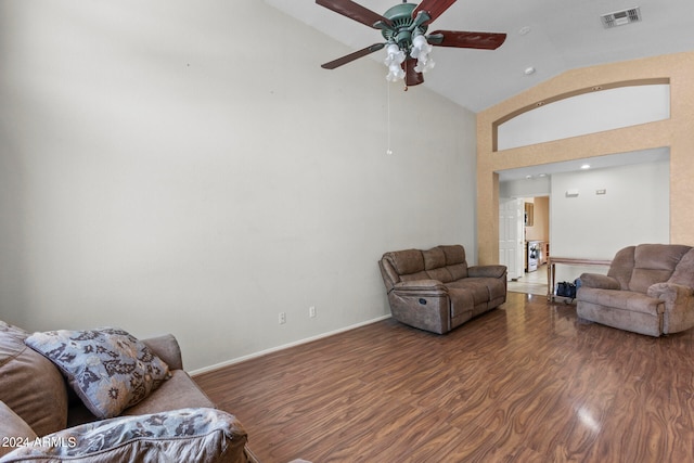 living room with ceiling fan, high vaulted ceiling, and dark wood-type flooring