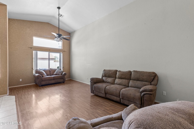 living room featuring ceiling fan, light hardwood / wood-style floors, and lofted ceiling