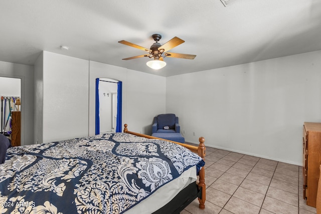 tiled bedroom featuring ceiling fan