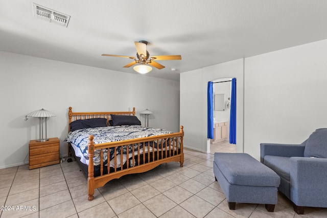 bedroom featuring ensuite bath, ceiling fan, and light tile patterned flooring