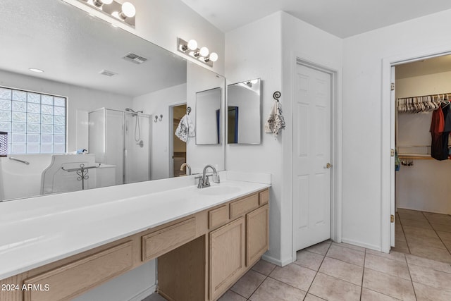 bathroom featuring vanity, tile patterned floors, and a shower with shower door