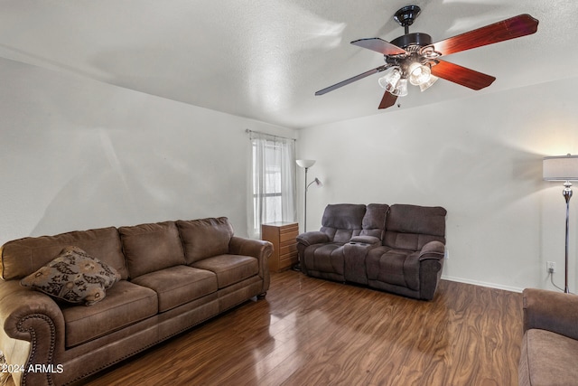 living room with hardwood / wood-style flooring, ceiling fan, and a textured ceiling