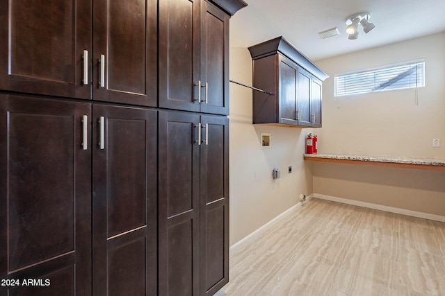 clothes washing area featuring cabinets, washer hookup, hookup for a gas dryer, hookup for an electric dryer, and light hardwood / wood-style floors