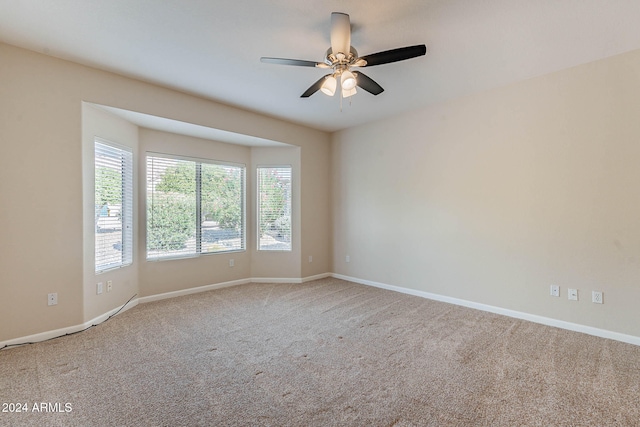 unfurnished room with ceiling fan and carpet flooring