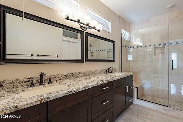 bathroom with vanity and a shower with shower door