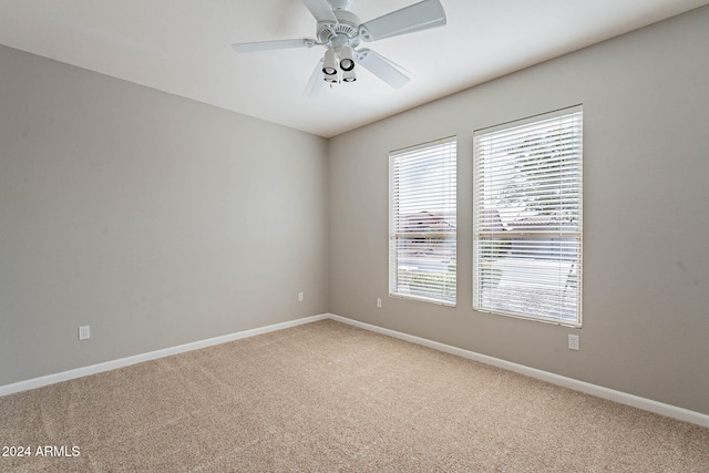 spare room featuring carpet floors and ceiling fan