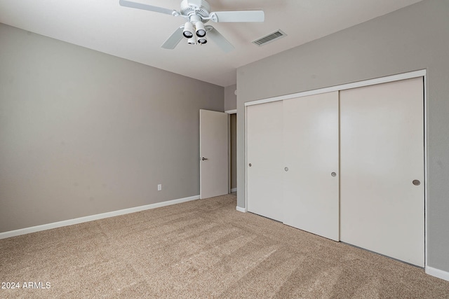 unfurnished bedroom featuring a closet, carpet, and ceiling fan