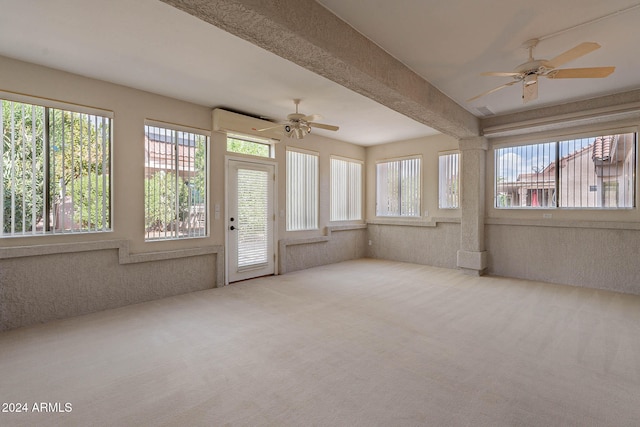 unfurnished sunroom featuring ceiling fan