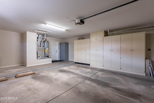 garage with water heater and a garage door opener