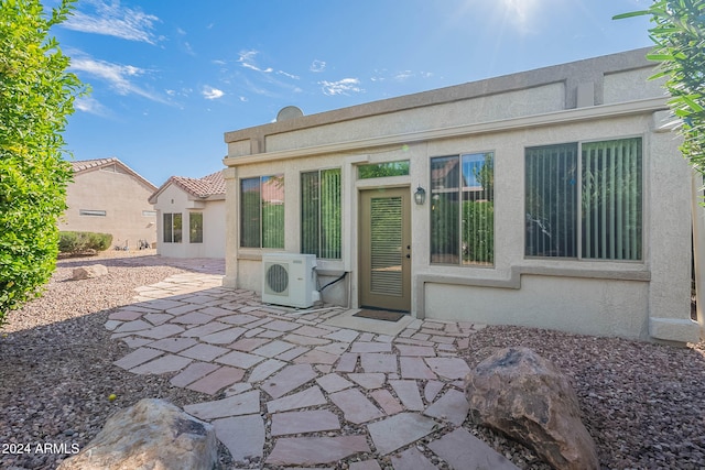 back of property with ac unit and a patio area