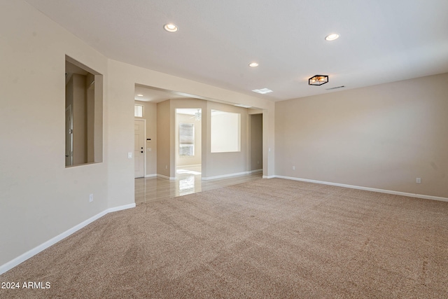 unfurnished room with light colored carpet