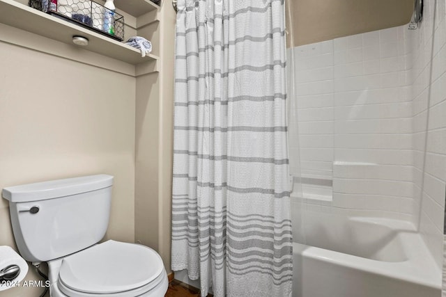 bathroom with shower / tub combo and toilet