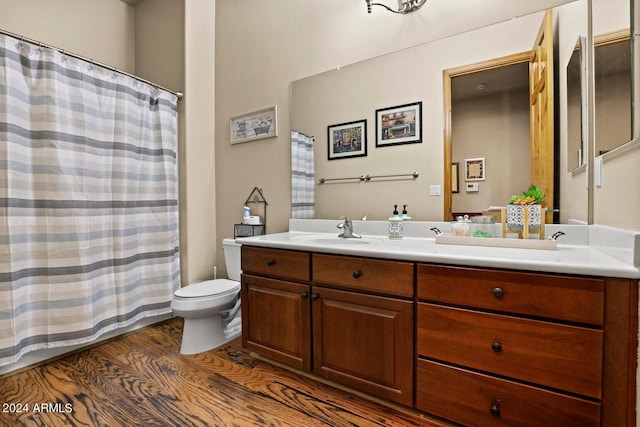 bathroom featuring vanity, hardwood / wood-style floors, and toilet