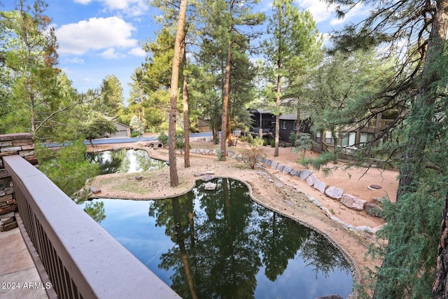 view of swimming pool featuring a water view