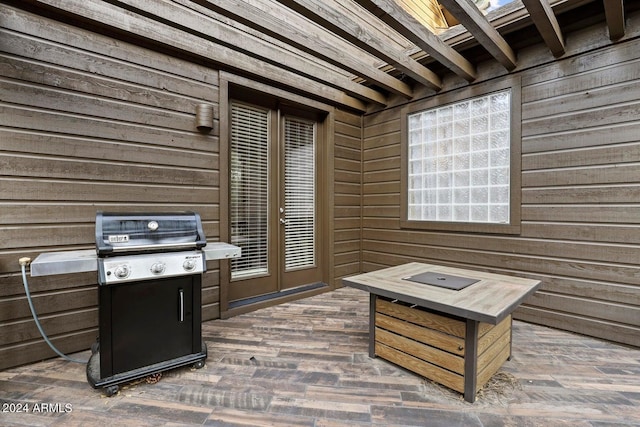 exterior space with dark wood-type flooring and wooden walls