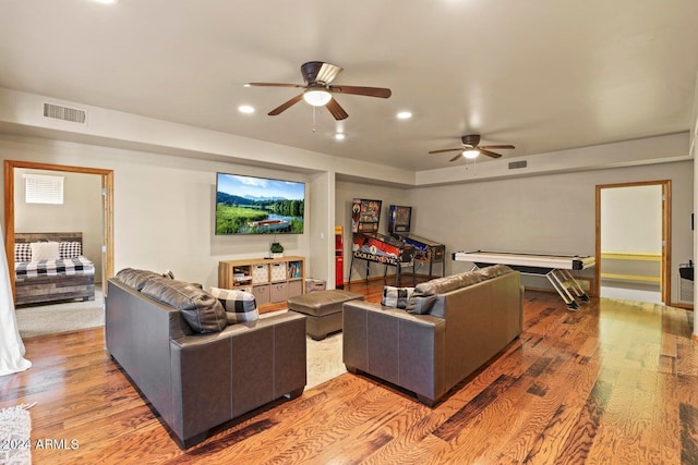 living room with hardwood / wood-style flooring and ceiling fan