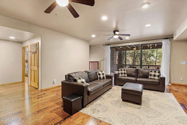 living room featuring light hardwood / wood-style floors and ceiling fan