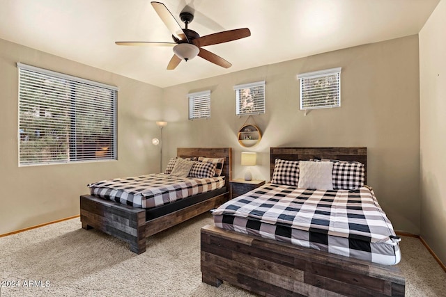 bedroom with ceiling fan and light carpet