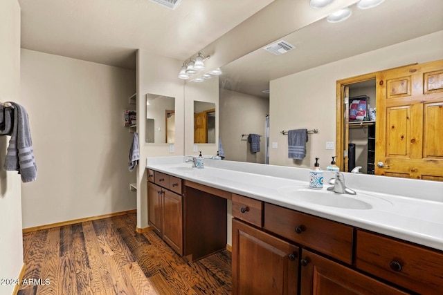 bathroom featuring vanity and hardwood / wood-style floors