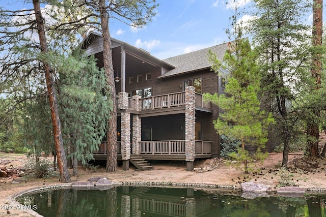 rear view of house featuring a balcony