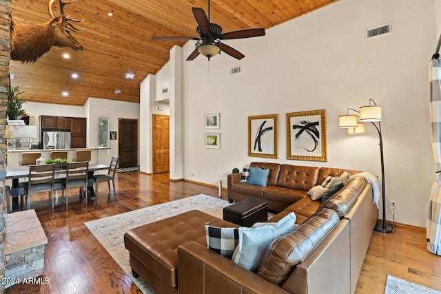 living room featuring high vaulted ceiling, light hardwood / wood-style flooring, wooden ceiling, and ceiling fan