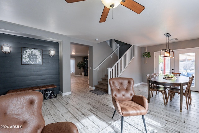 living room with ceiling fan, french doors, and light hardwood / wood-style floors